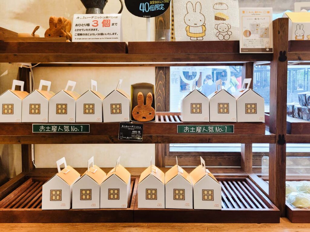 miffy shaped milk bread inside a cardboard house box on shelves in the miffy cafe